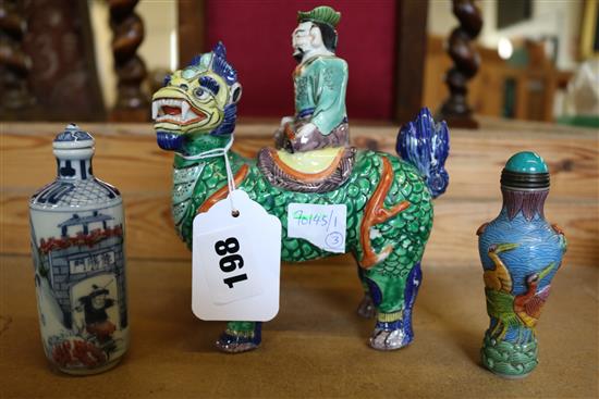 A Chinese porcelain figure on a beast and two snuff bottles